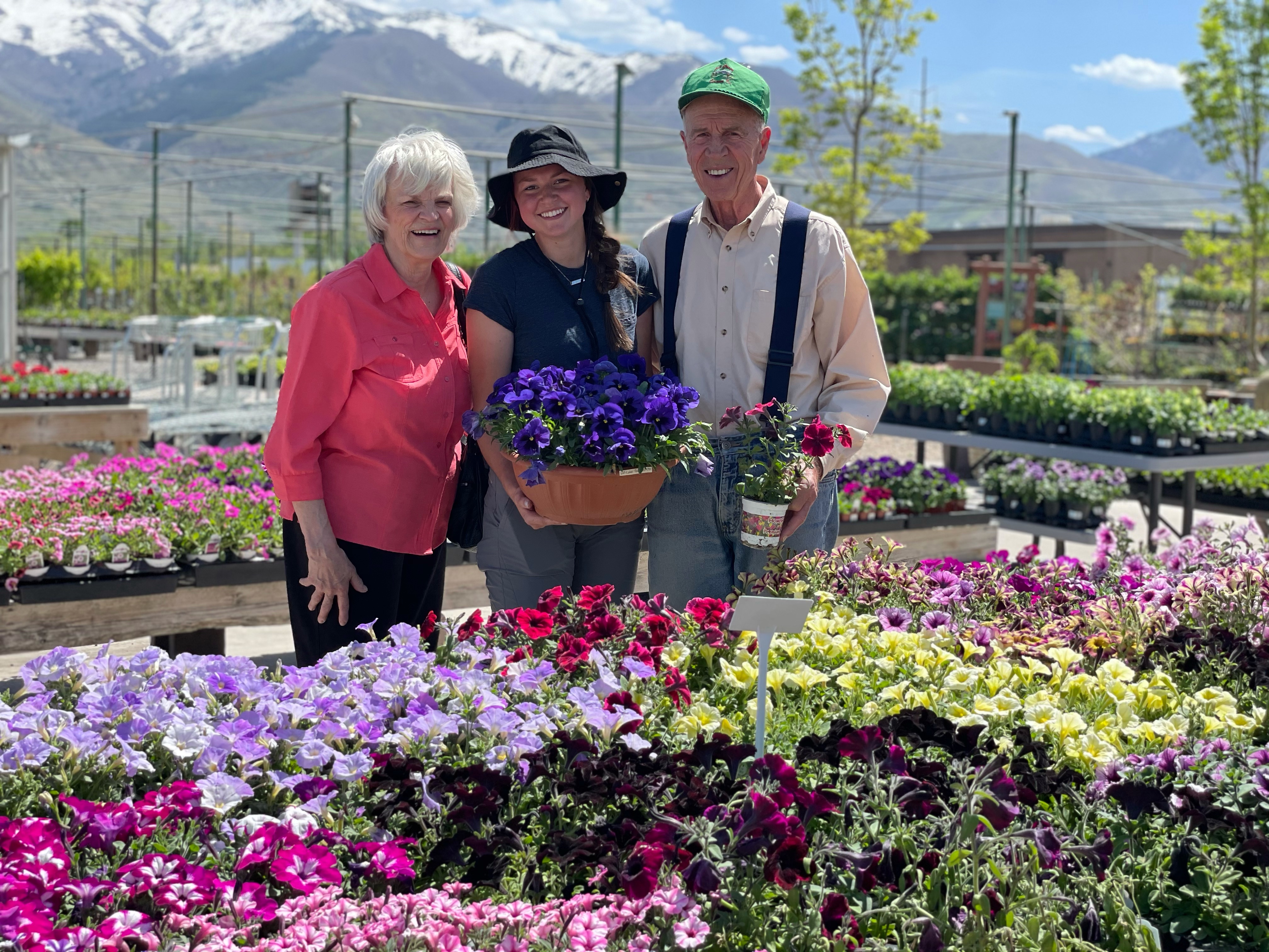 family smiling standing amongst flowers at botanicals kaysville garden center retail location