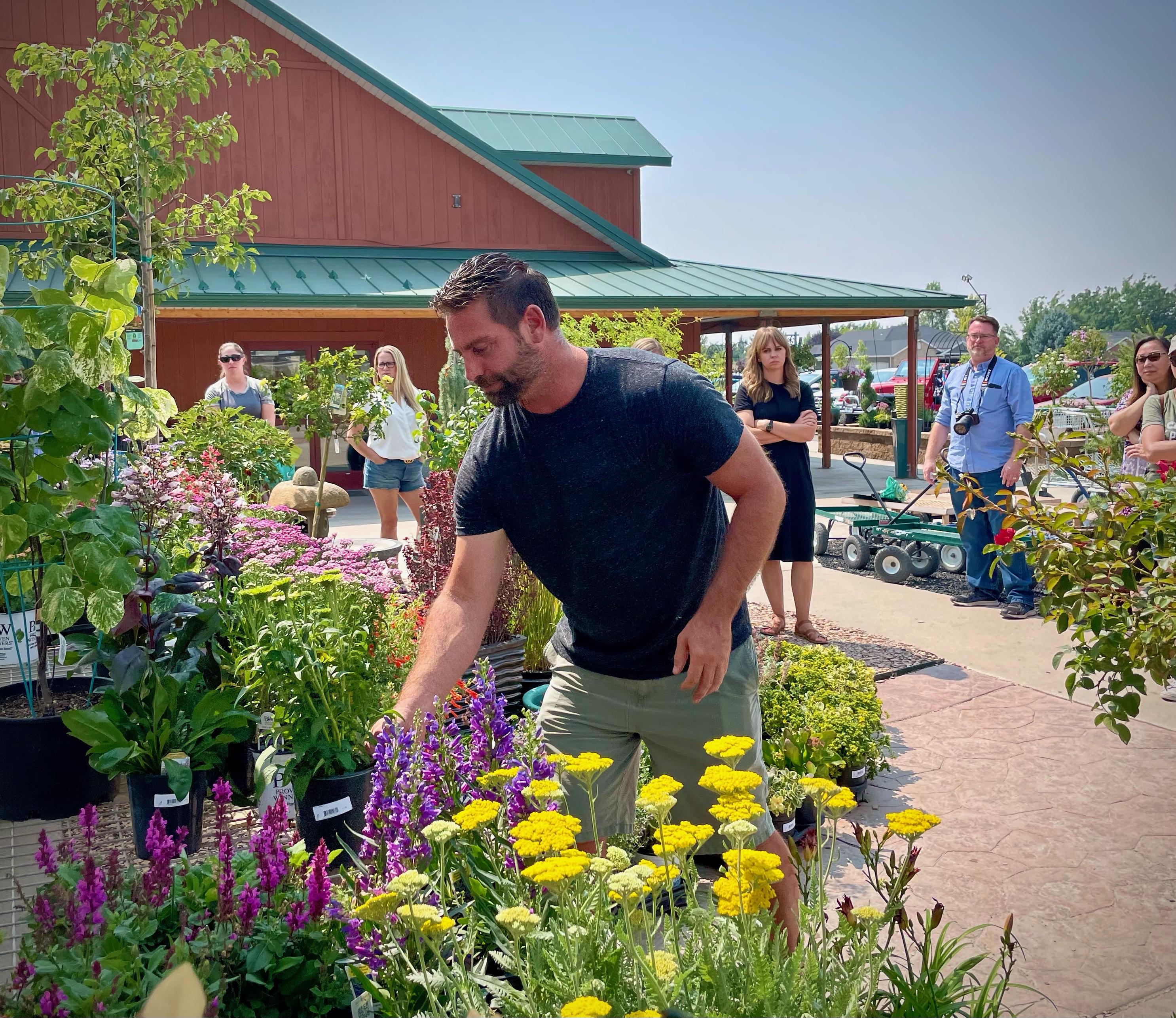 man shopping amongst several varieties of flowers at botanicals kaysville garden center