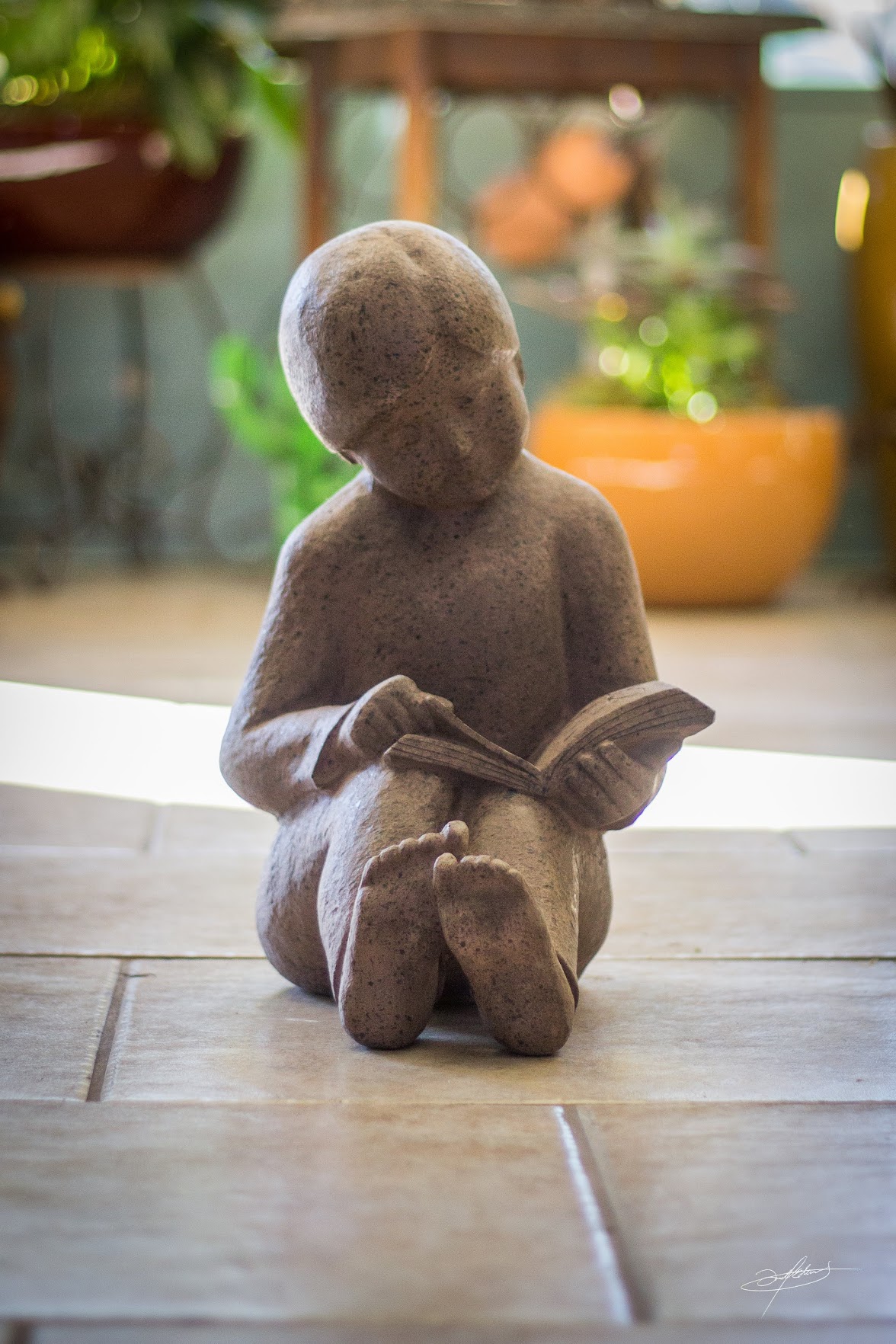 statue of child reading at botanicals saint george